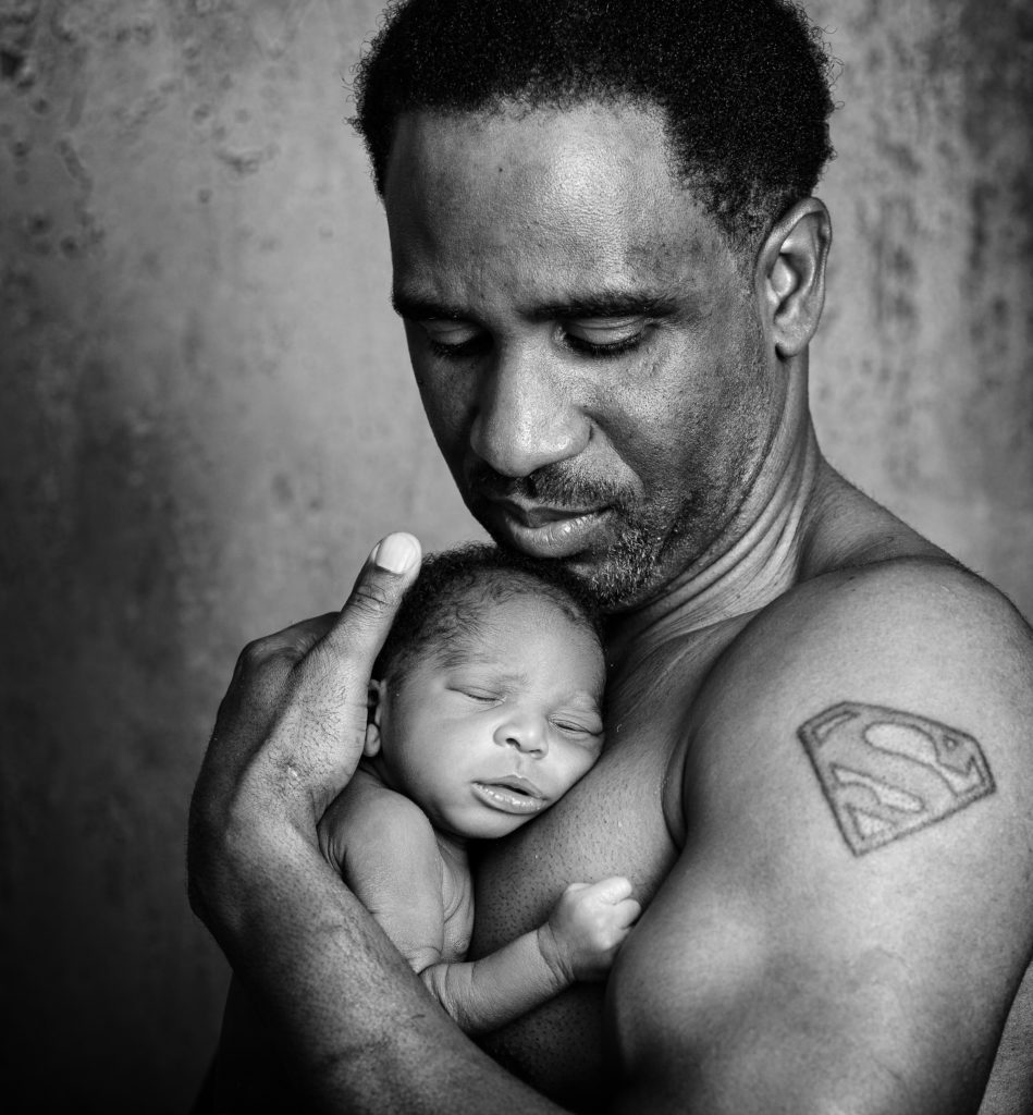 Father holding newborn son