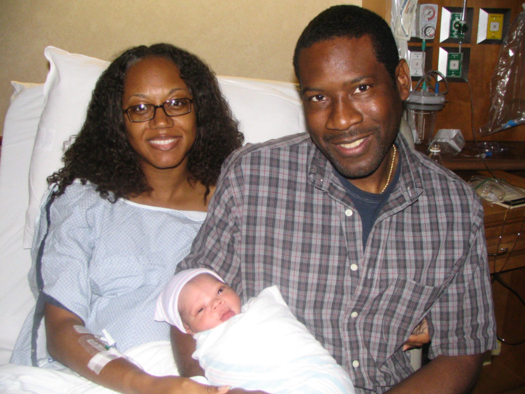 New parents holding newborn