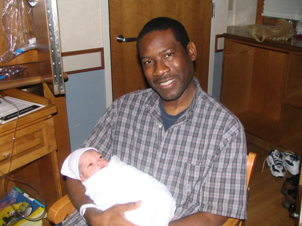 Father holding newborn son