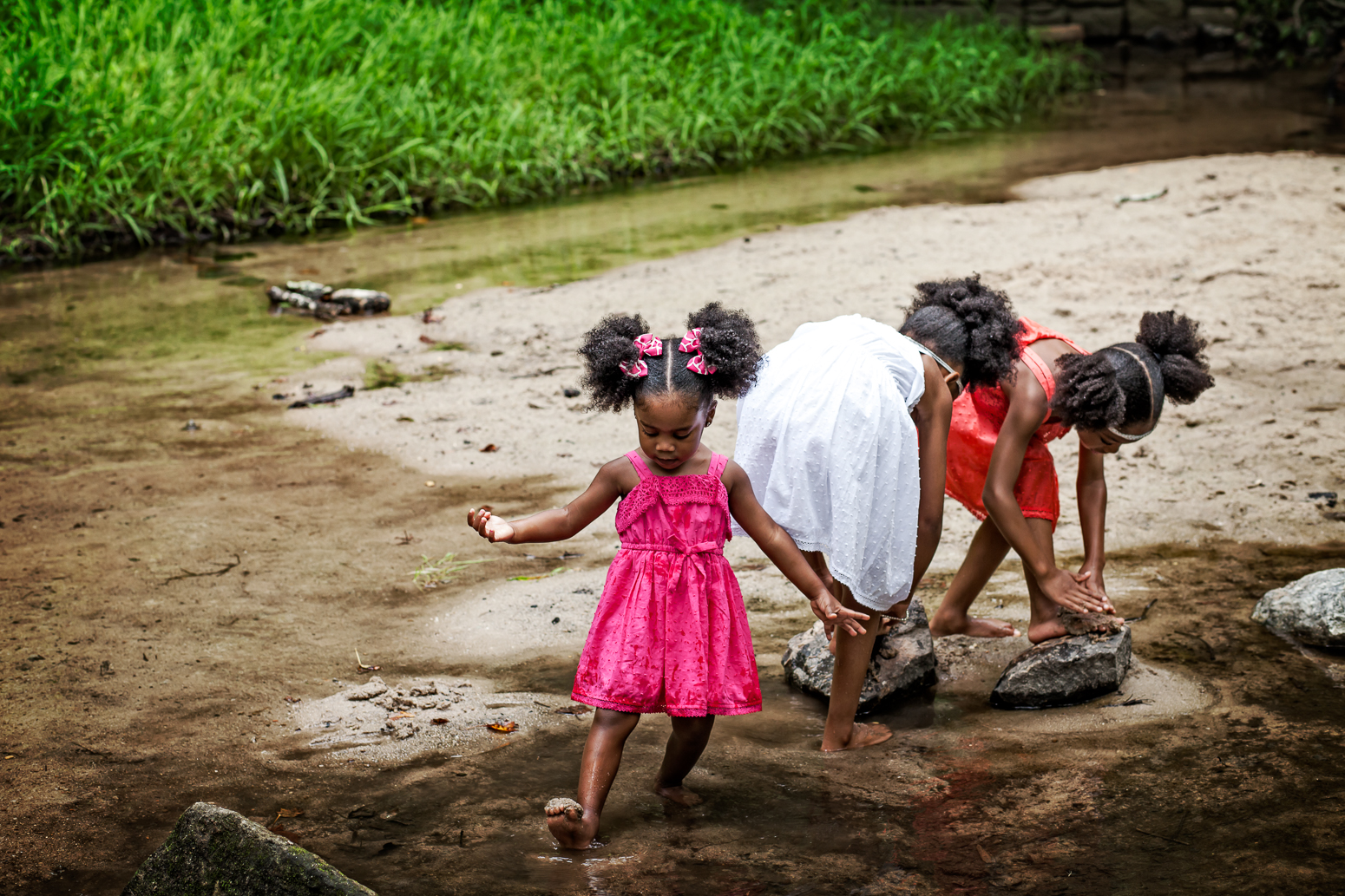 sisters playing in a stream