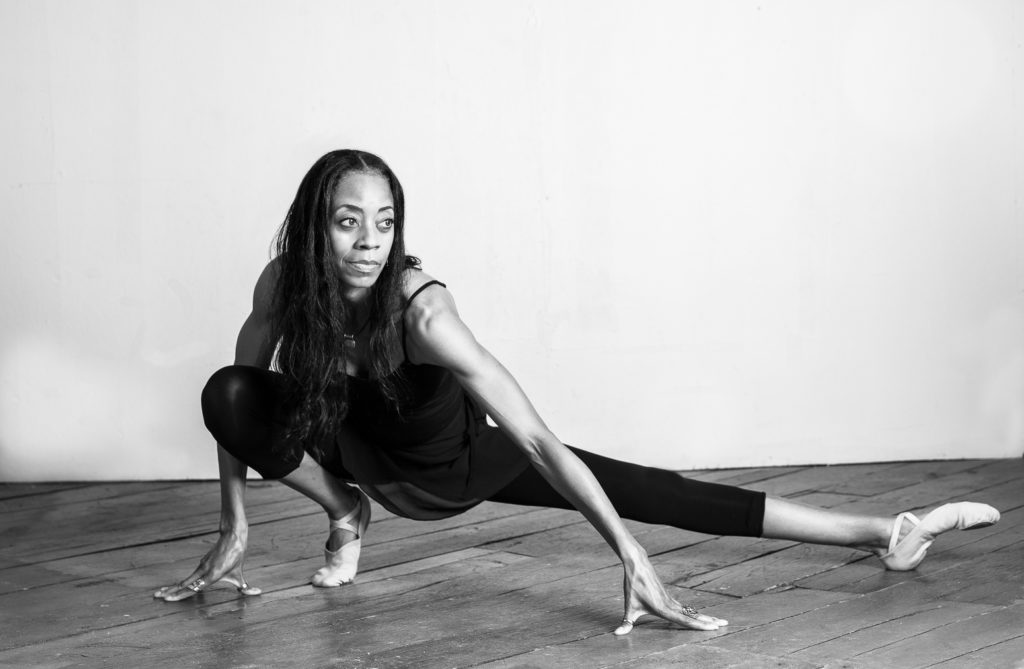 Black and white image of dancer stretching