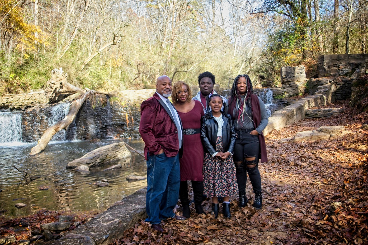 Portrait of a black family of five near a waterfall